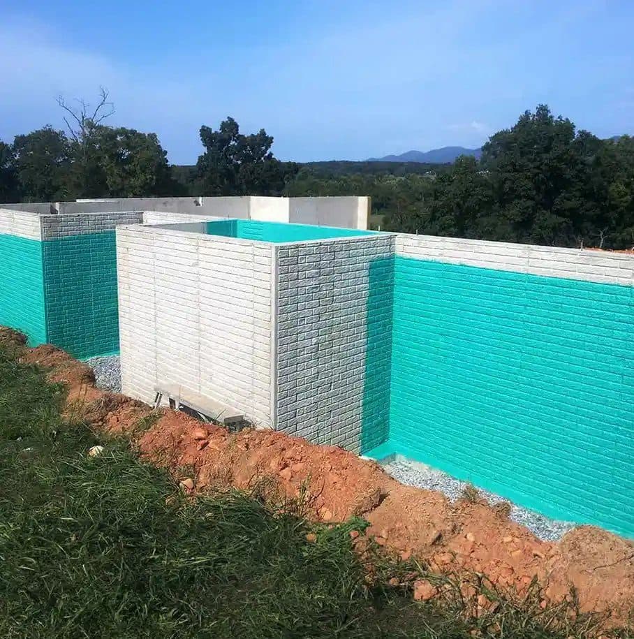 Teal Rub-R-Wall on a textured faux-brick poured foundation wall
