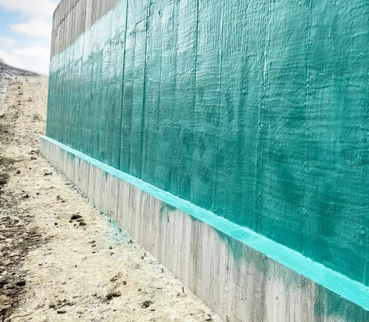 Teal Rub-R-Wall membrane covering the wall-to-footing cove on poured concrete